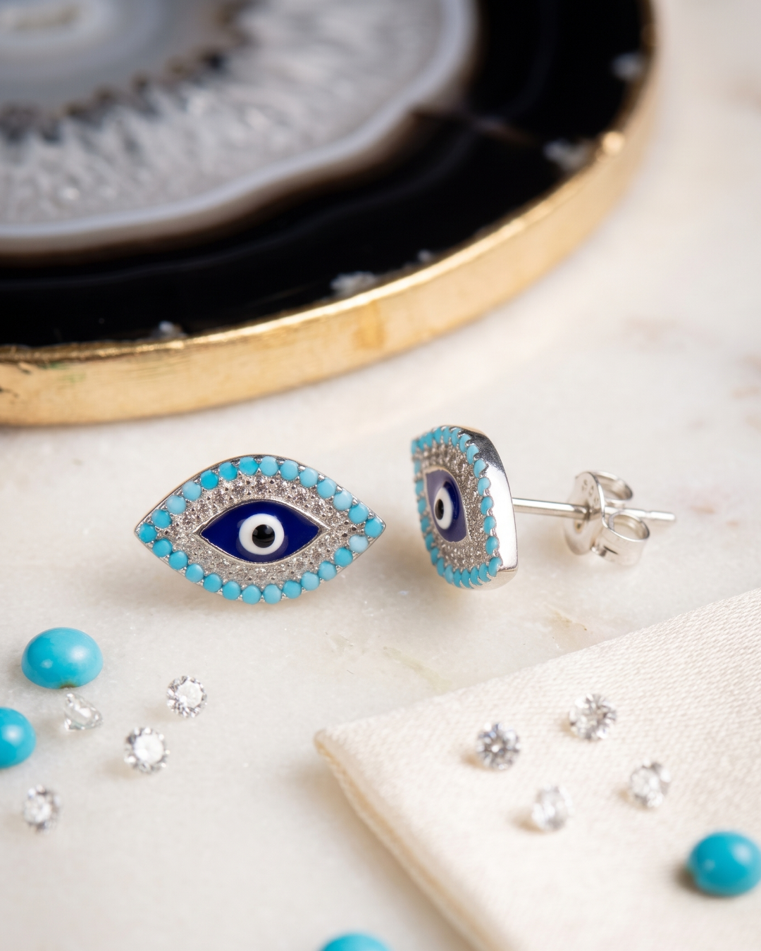 Artisan crafted sterling silver and cubic zirconia evil eye tops
