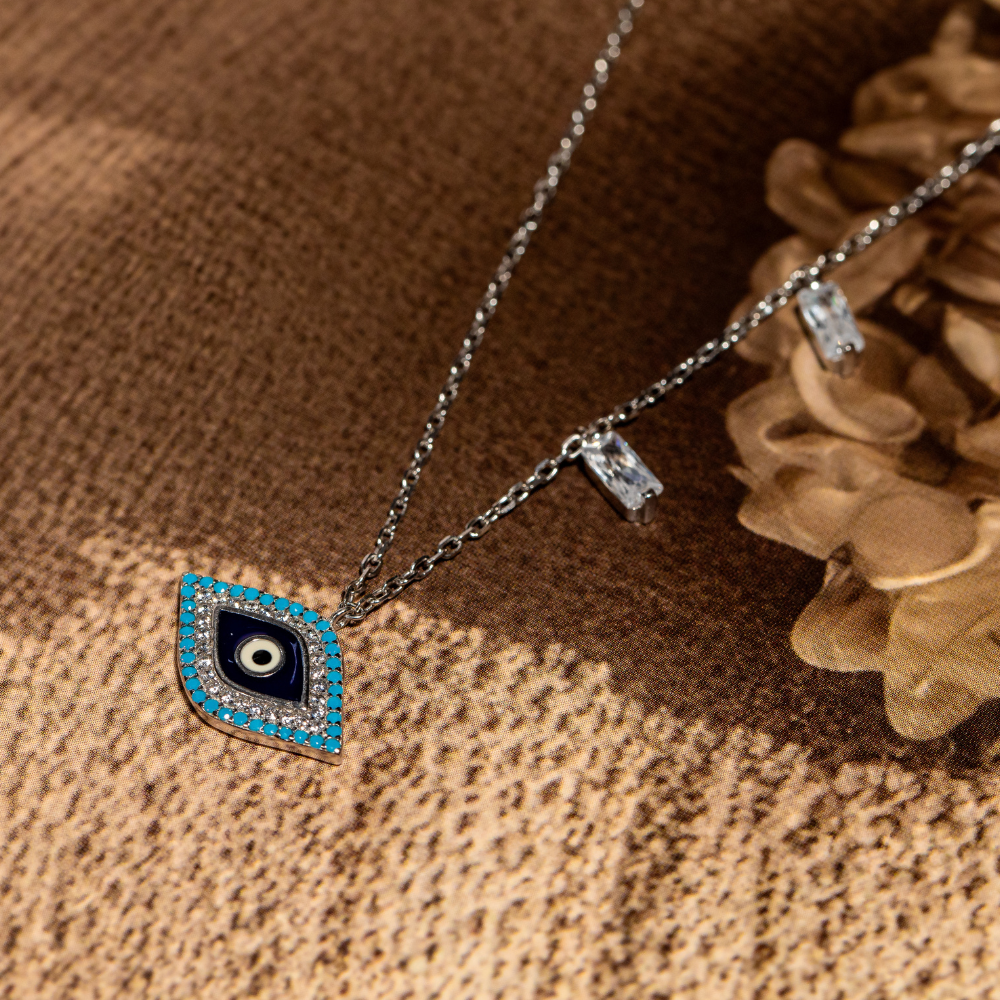 Sterling silver evil eye pendant necklace featuring a central eye motif with turquoise and cubic zirconia accents