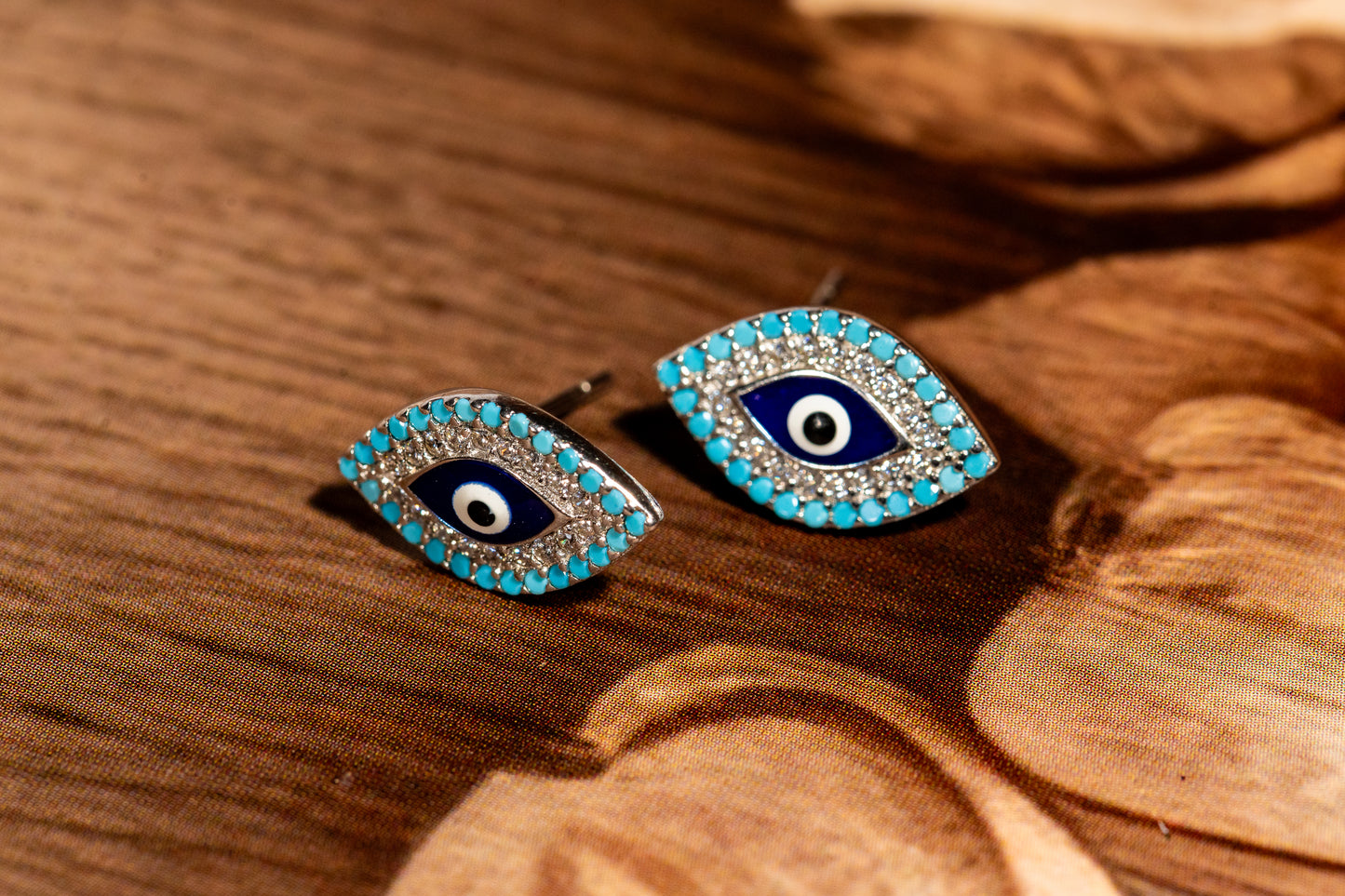 Artisan crafted sterling silver and cubic zirconia evil eye tops