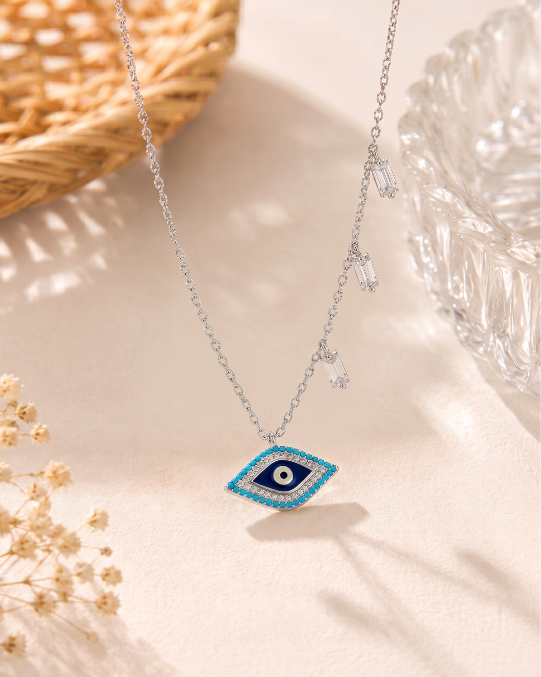 Sterling silver evil eye pendant necklace featuring a central eye motif with turquoise and cubic zirconia accents