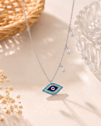 Sterling silver evil eye pendant necklace featuring a central eye motif with turquoise and cubic zirconia accents