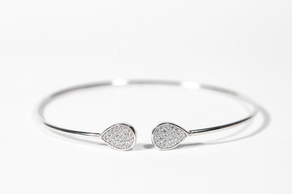 Sterling silver open cuff bangle featuring pear shaped accents embellished with cubic zirconia