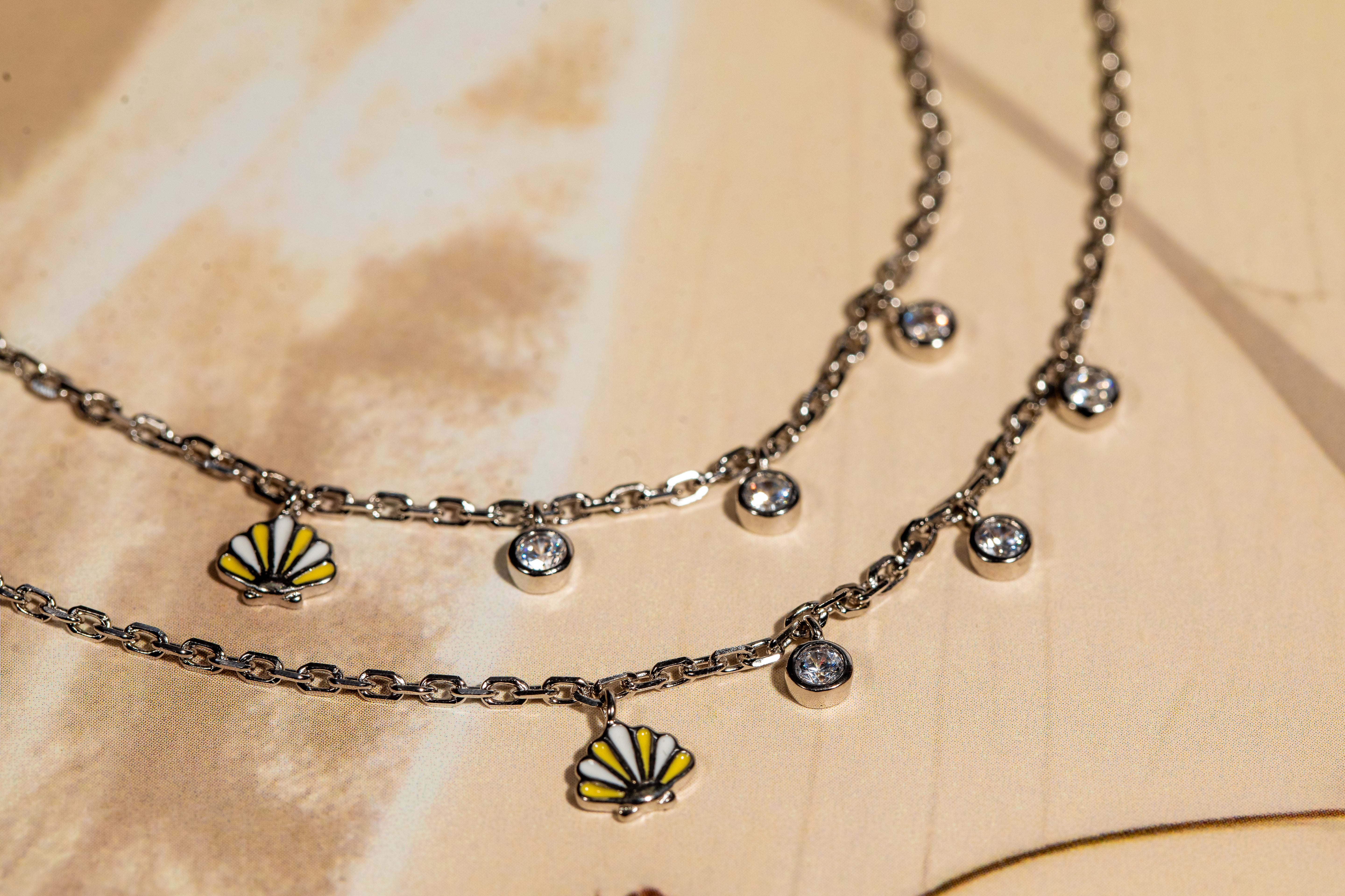 Sterling silver anklets with shell and crystal charms in cubic zirconia