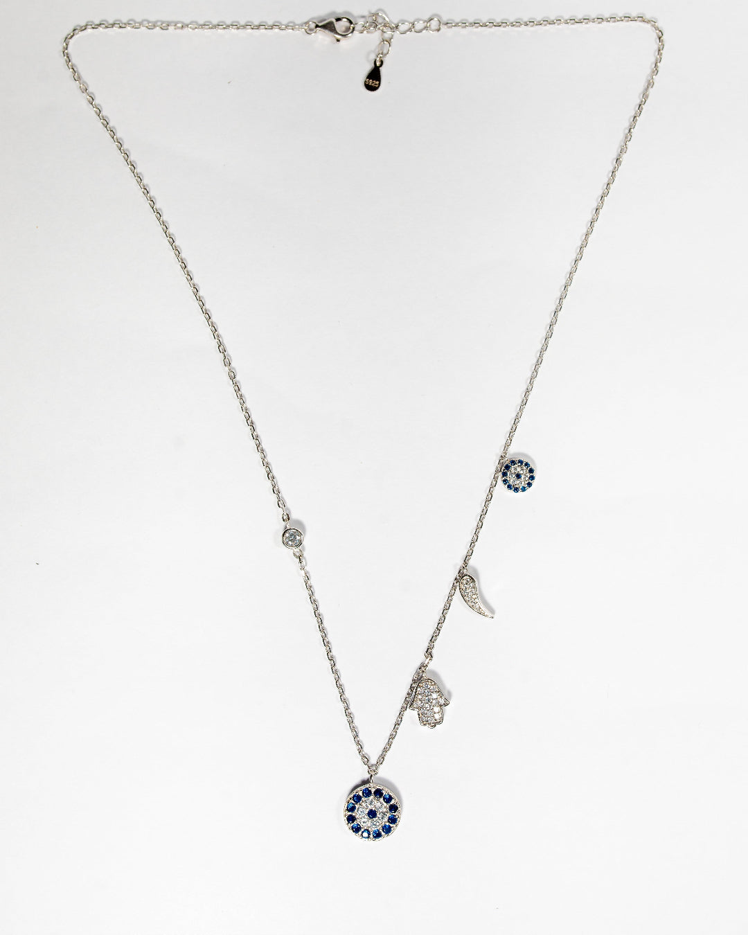 Sterling silver charm necklace featuring evil eye, hamsa hand and other luck charms
