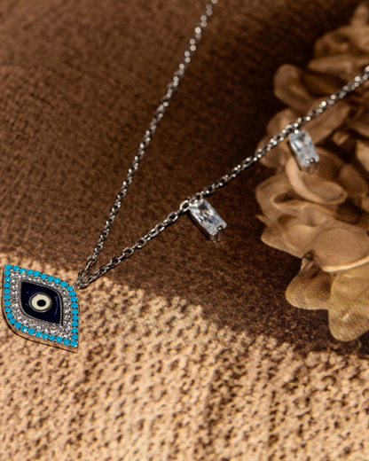 Sterling silver evil eye pendant necklace featuring a central eye motif with turquoise and cubic zirconia accents