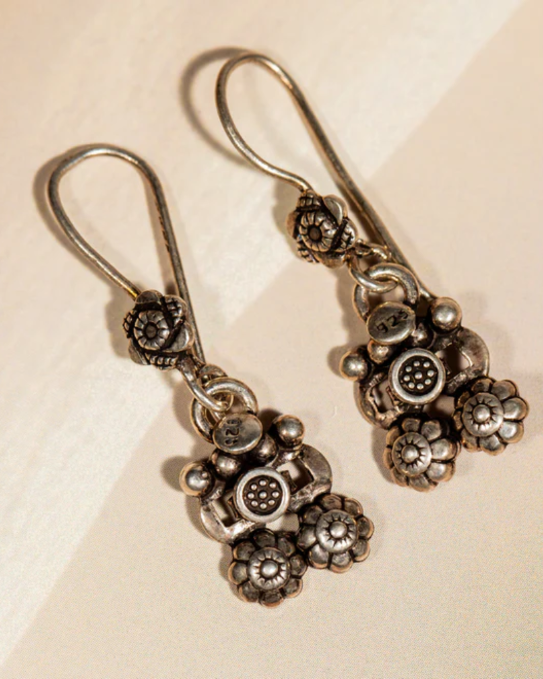 Oxidised silver dangle earrings featuring tribal floral motifs