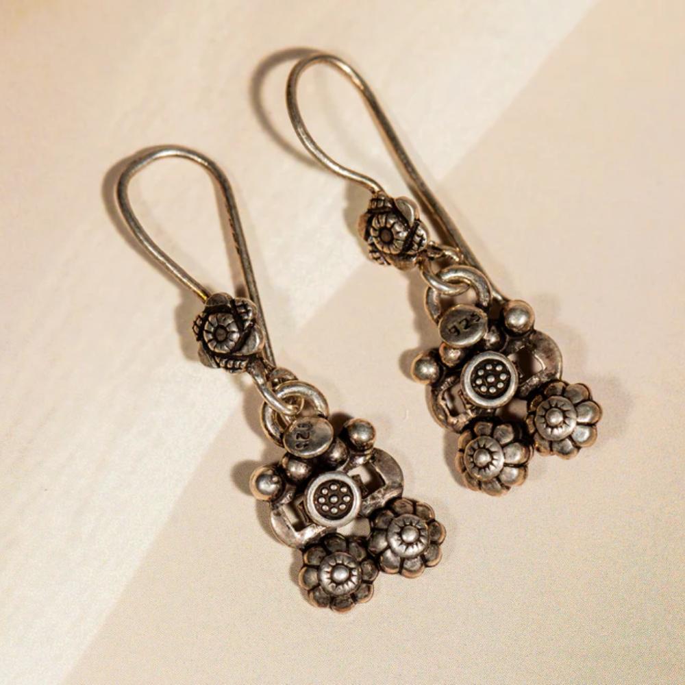 Oxidised silver dangle earrings featuring tribal floral motifs